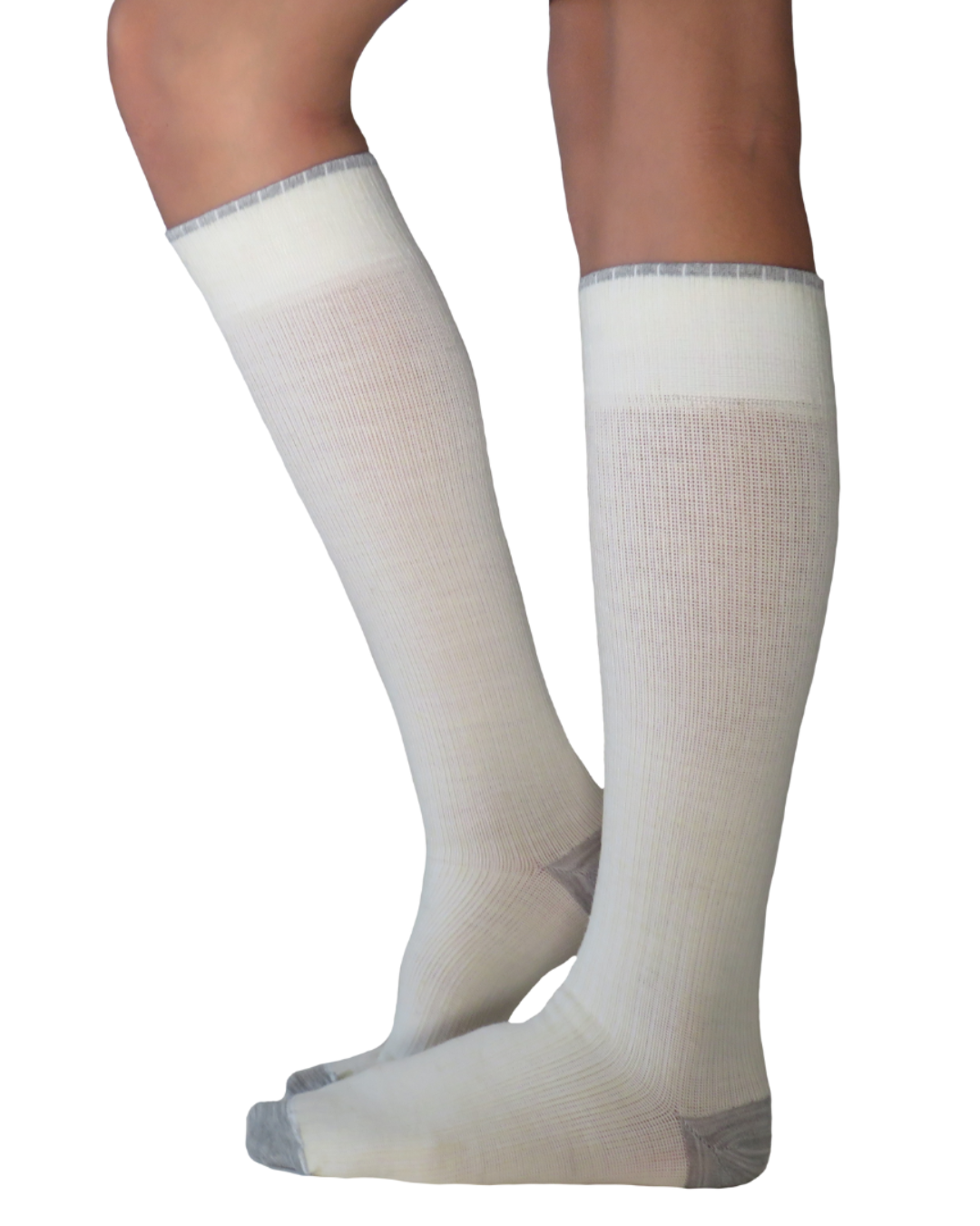 A pair of natural and grey colour merino wool knee-high compression socks worn on a model&
