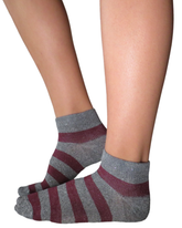 Grey marl and burgundy striped ankle compression socks worn on feet.