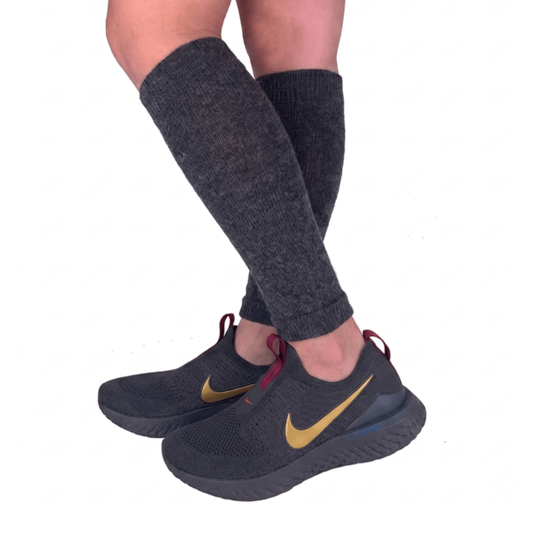YoU Compression® Charcoal Alpaca Wool Leg Sleeves 20-30 mmHg, worn on lower legs with dark athletic shoes featuring a gold Nike swoosh logo, against a white background.