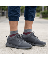 YoU Compression® Grey & Burgundy 20-30 mmHg Ankle Socks worn on feet with dark gray athletic sneakers and cuffed navy pants.